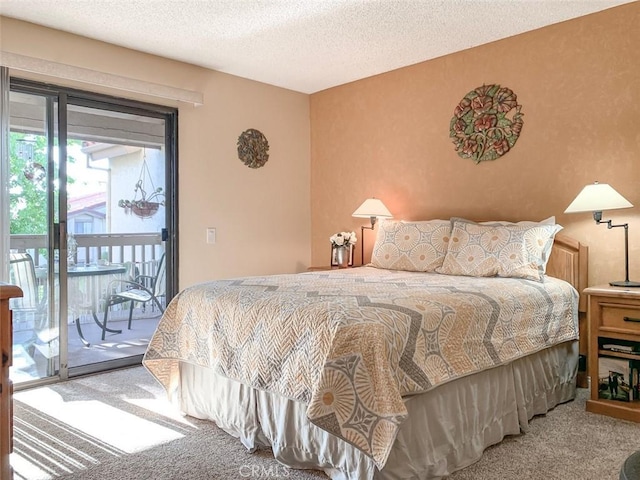 bedroom featuring access to exterior, carpet, and a textured ceiling