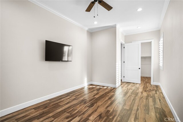 unfurnished living room featuring ceiling fan, hardwood / wood-style floors, and ornamental molding