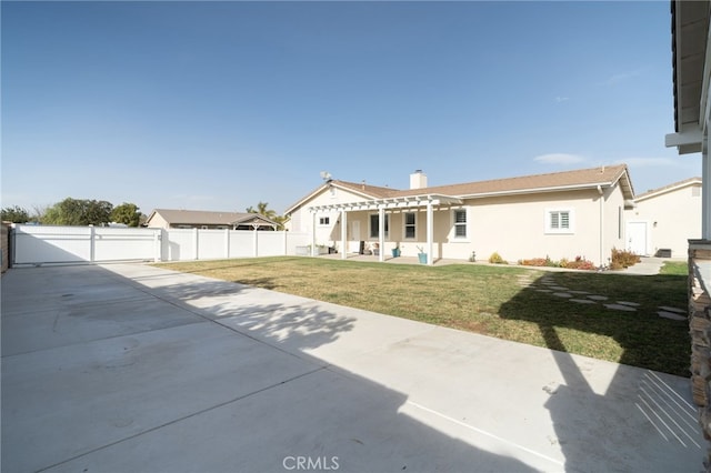 back of property featuring a pergola, a patio area, and a lawn