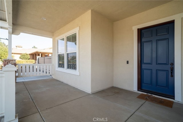 doorway to property featuring a porch