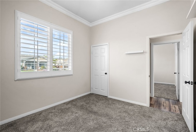 unfurnished bedroom featuring carpet, a closet, and crown molding