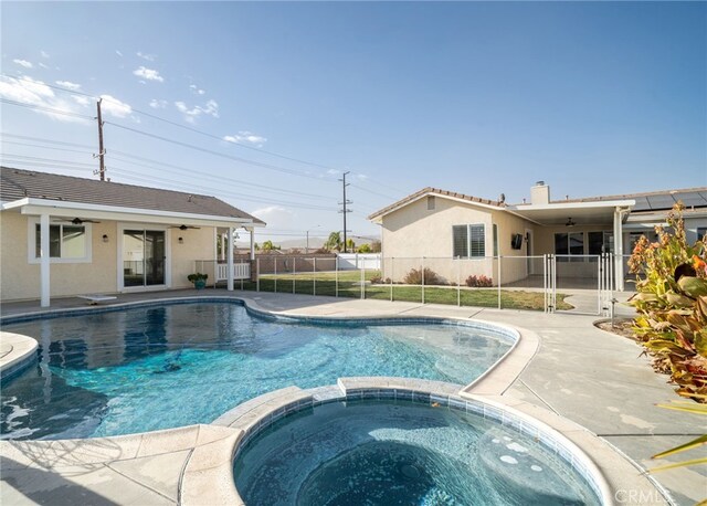 view of pool featuring a patio and an in ground hot tub