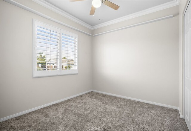 carpeted empty room with ceiling fan and ornamental molding