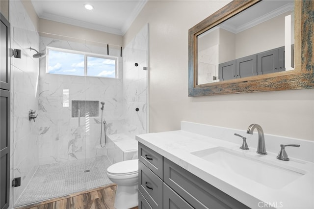 bathroom with a shower with door, hardwood / wood-style floors, vanity, and ornamental molding