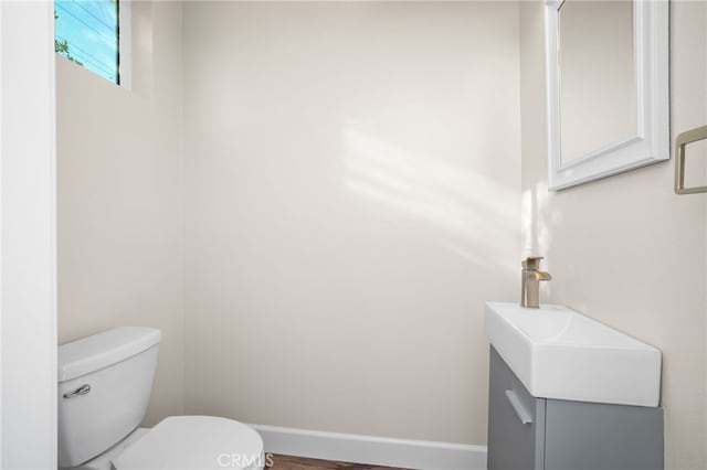 bathroom featuring toilet and vanity