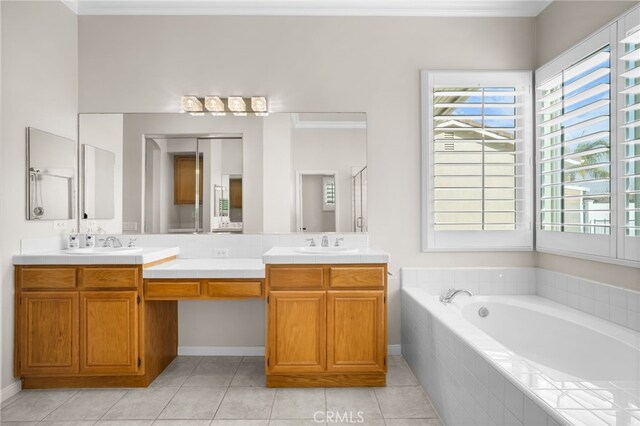 bathroom with tiled bath, vanity, tile patterned floors, and ornamental molding