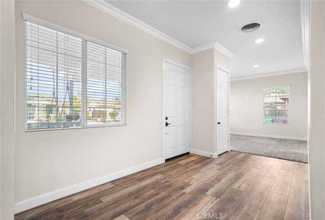 foyer with dark hardwood / wood-style floors and ornamental molding