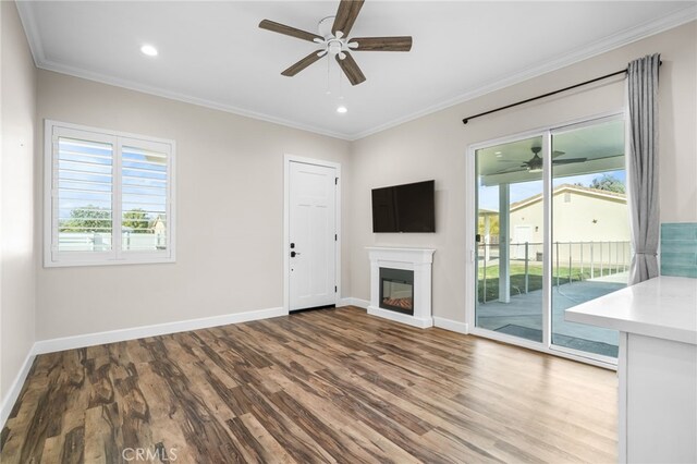 unfurnished living room with ceiling fan, ornamental molding, and hardwood / wood-style flooring