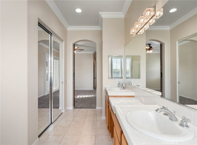 bathroom with ceiling fan, tile patterned flooring, crown molding, and vanity