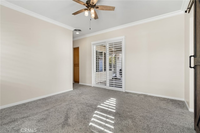 empty room featuring carpet floors, crown molding, and ceiling fan