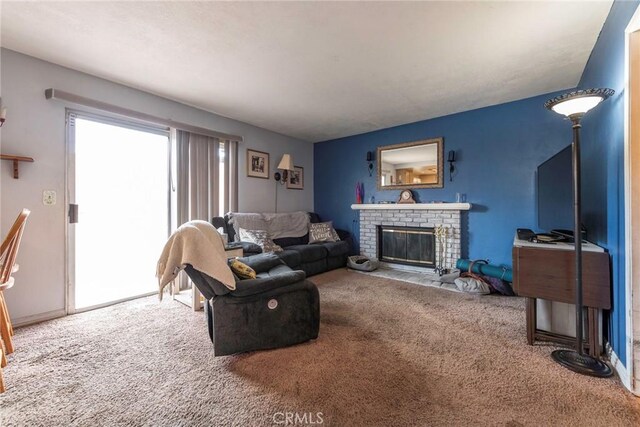 living room featuring carpet and a fireplace