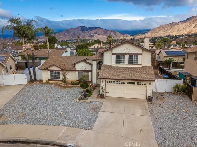 view of front of home with a garage and a mountain view