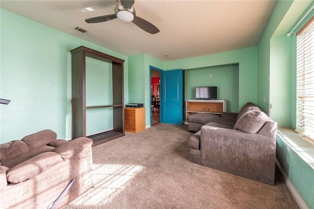 living room featuring ceiling fan and carpet flooring