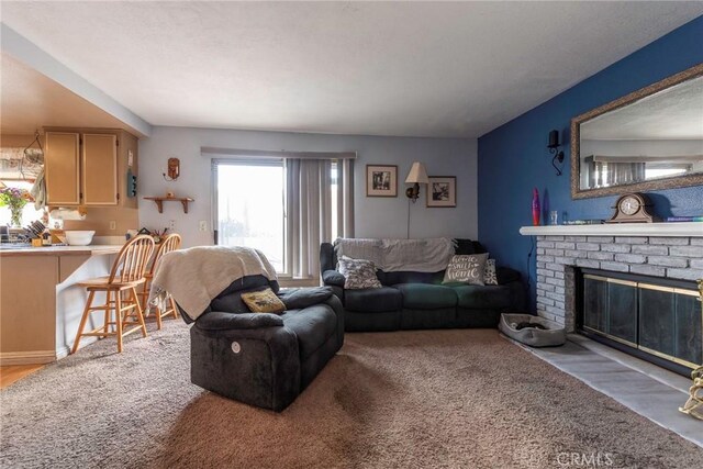 carpeted living room featuring a fireplace