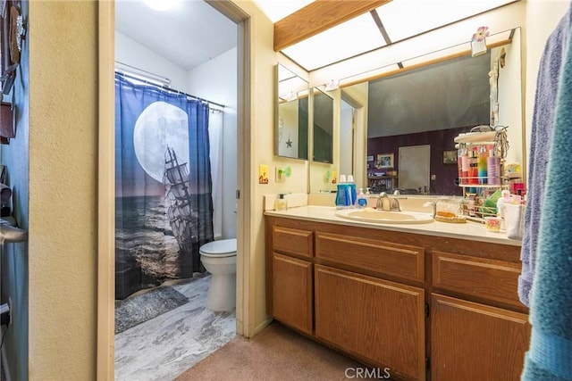 bathroom featuring toilet, vanity, and a shower with shower curtain