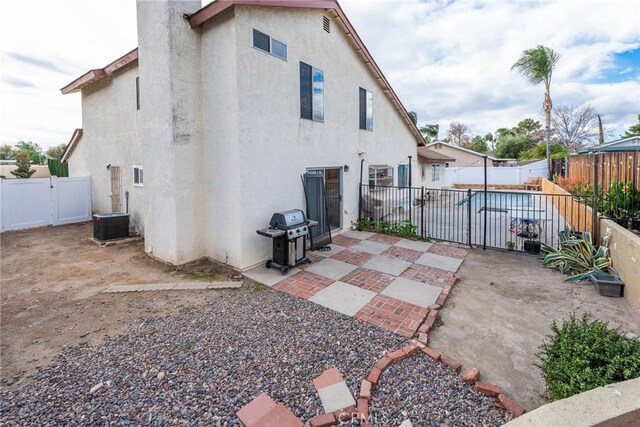 back of property featuring central AC unit and a patio area