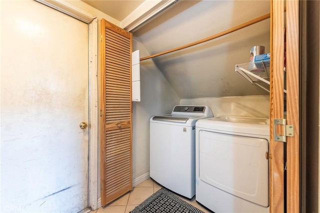 laundry room featuring light tile patterned flooring and washing machine and clothes dryer