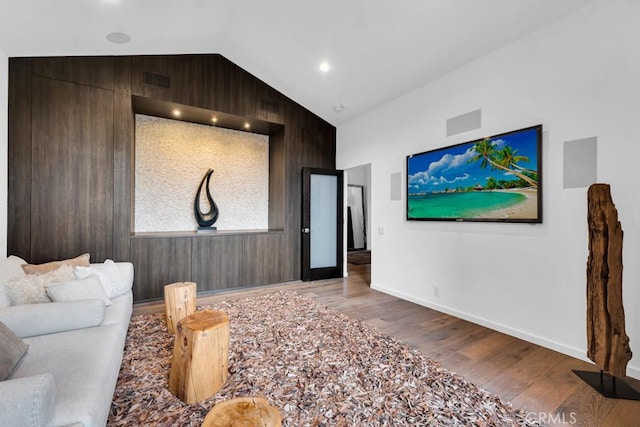 living room featuring hardwood / wood-style floors and lofted ceiling