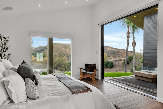 bedroom with a mountain view and hardwood / wood-style floors