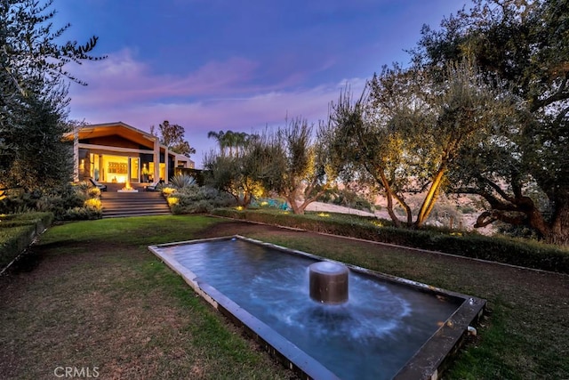 view of yard at dusk