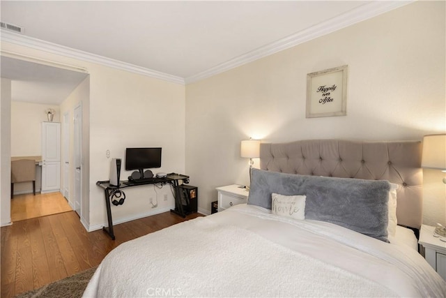 bedroom featuring dark hardwood / wood-style flooring and crown molding