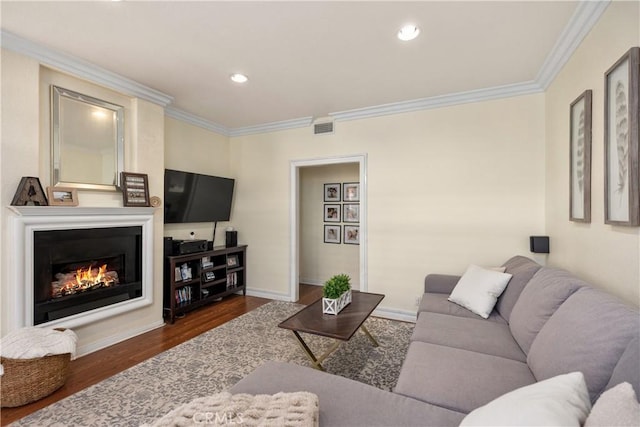 living room featuring crown molding and dark hardwood / wood-style floors