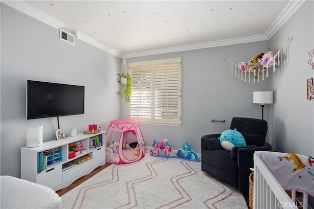 playroom with ornamental molding and wood-type flooring