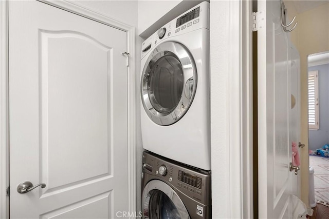 laundry room with stacked washer / dryer