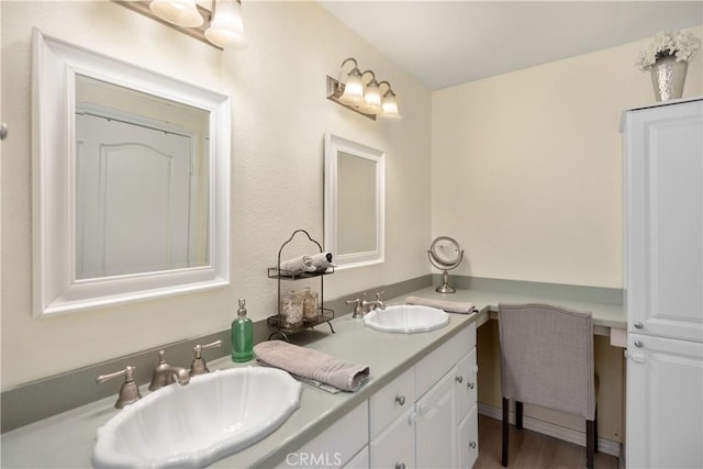 bathroom with vanity and hardwood / wood-style flooring