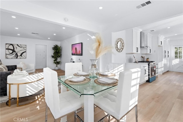 dining space with light hardwood / wood-style flooring