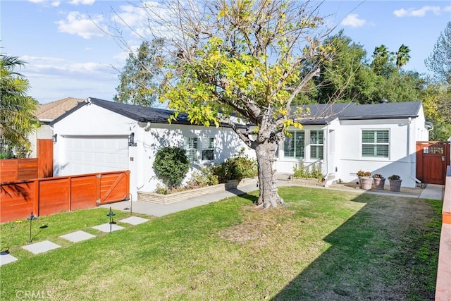 single story home featuring a front lawn and a garage