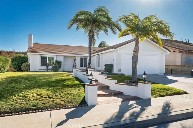 view of front of home featuring a front yard and a garage