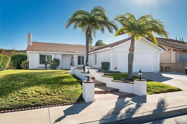 view of front of home with a front lawn and a garage