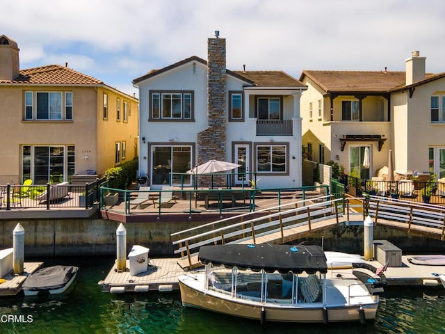 rear view of property with a water view