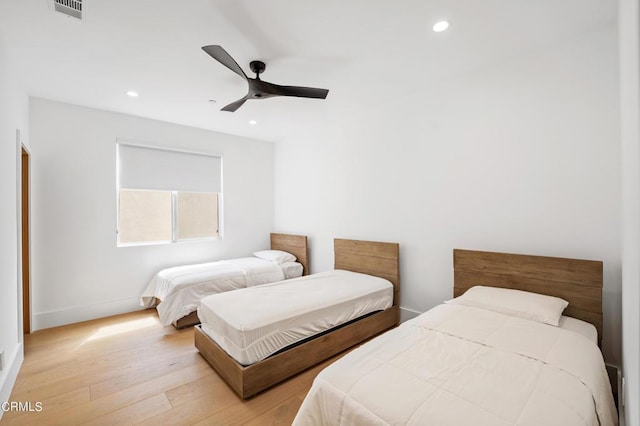 bedroom with light wood-type flooring and ceiling fan