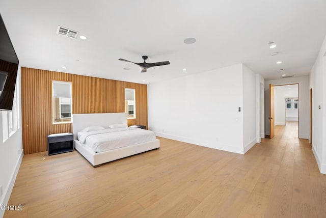 bedroom with ceiling fan and light hardwood / wood-style flooring