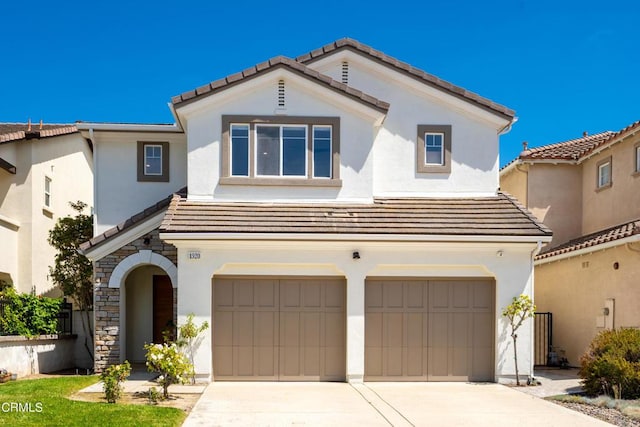 mediterranean / spanish house with a garage