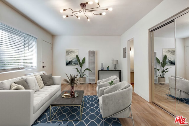 living room featuring a chandelier and hardwood / wood-style flooring