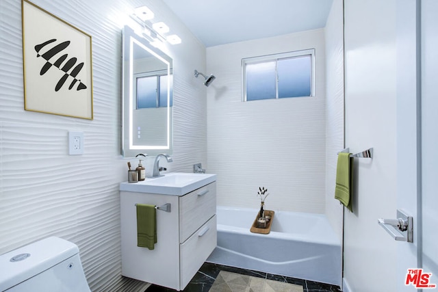 full bathroom featuring toilet, vanity, and tiled shower / bath