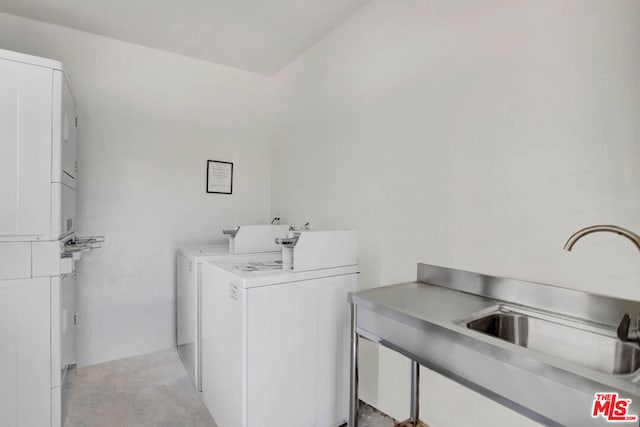 clothes washing area with washer and dryer and sink