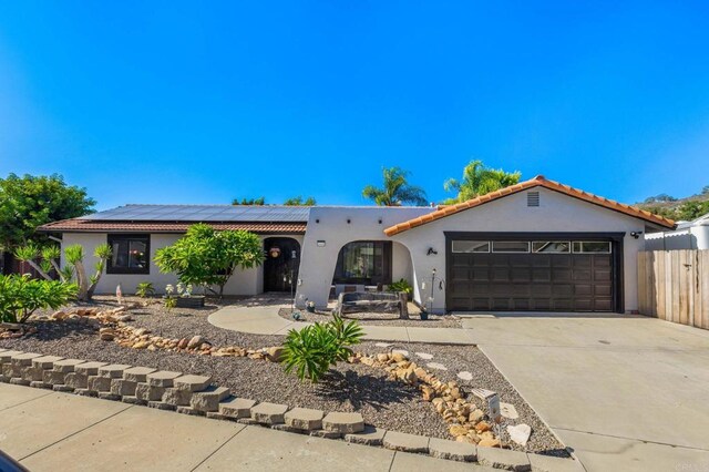 view of front of house featuring solar panels and a garage