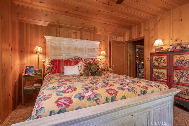 carpeted bedroom with wooden ceiling and wooden walls