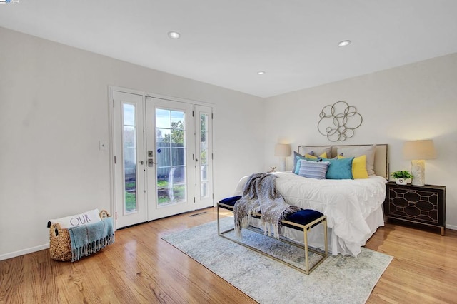 bedroom featuring hardwood / wood-style floors and access to exterior