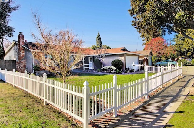 ranch-style home featuring a front lawn and a garage