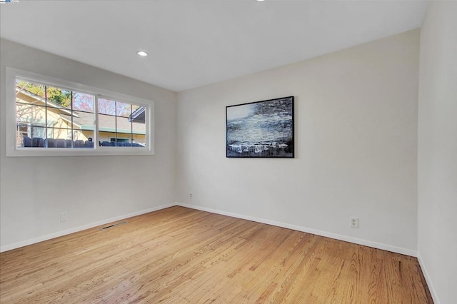 spare room featuring light wood-type flooring