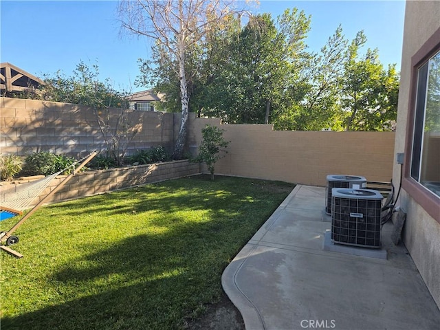 view of yard featuring central AC unit and a patio area