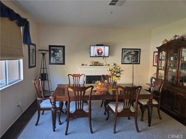 dining room featuring a tile fireplace