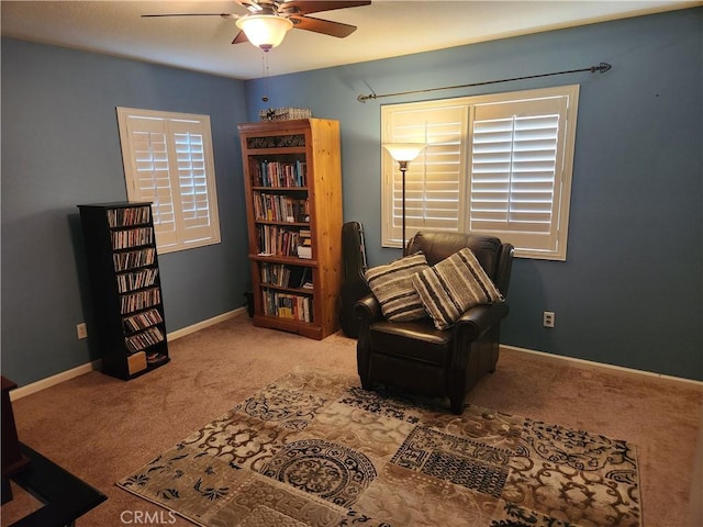 sitting room with carpet flooring, ceiling fan, and a healthy amount of sunlight