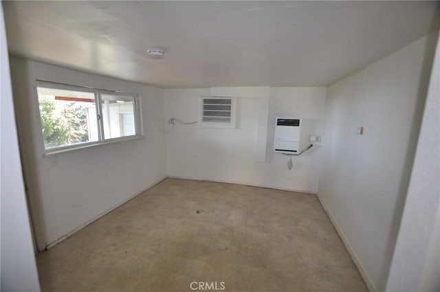 carpeted empty room featuring heating unit