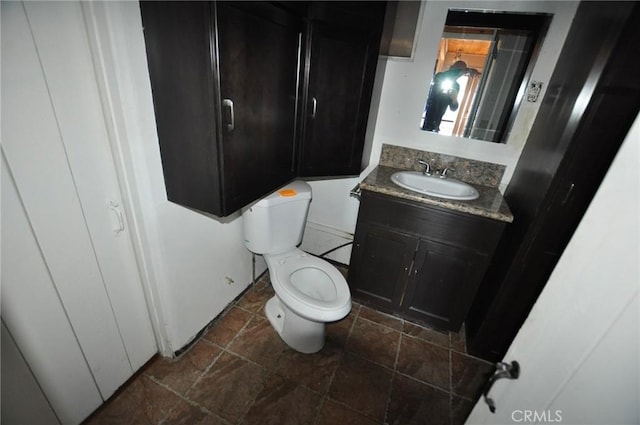 bathroom featuring toilet and vanity